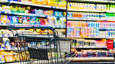 A shopping cart by a store shelf in a supermarket; Shutterstock ID 2265229445