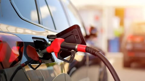 Close-Up of Fuel Nozzle Refueling Black Car at Gas Station During Sunset; Shutterstock ID 2644445047