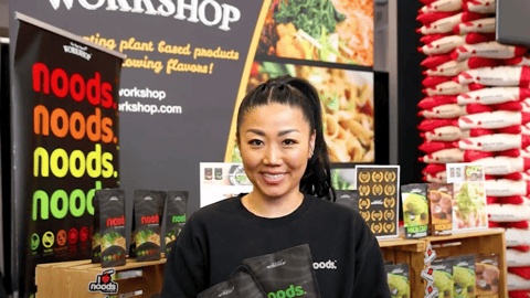 MAYUMI BAE, co-founder, The Plant Based Workshop at a booth on the trade show floor at GSF West