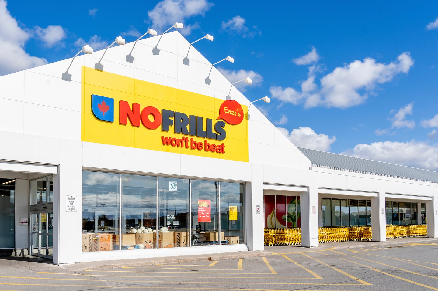 The outside of a No Frills grocery store on a sunny day