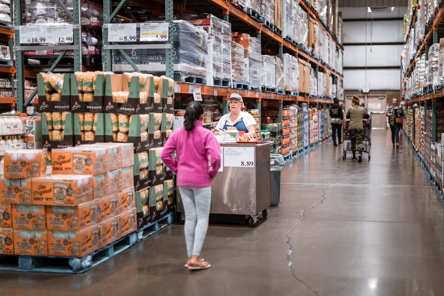 Costco wholesale warehouse shopping aisle with food testing