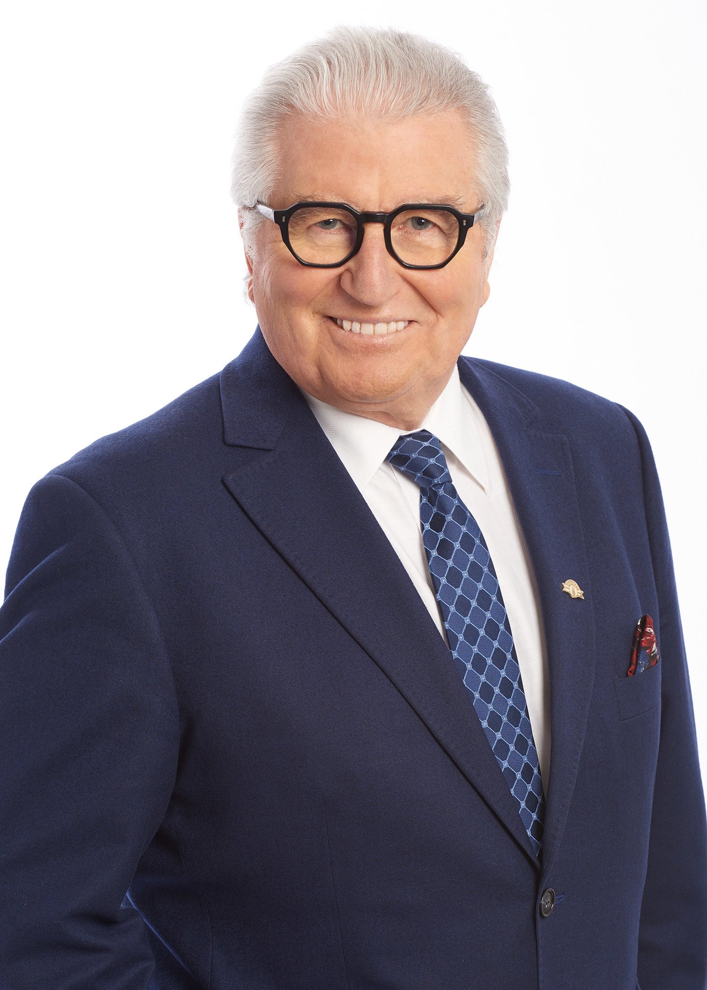 Olymel president and CEO Réjean Nadeau wearing a suit and tie