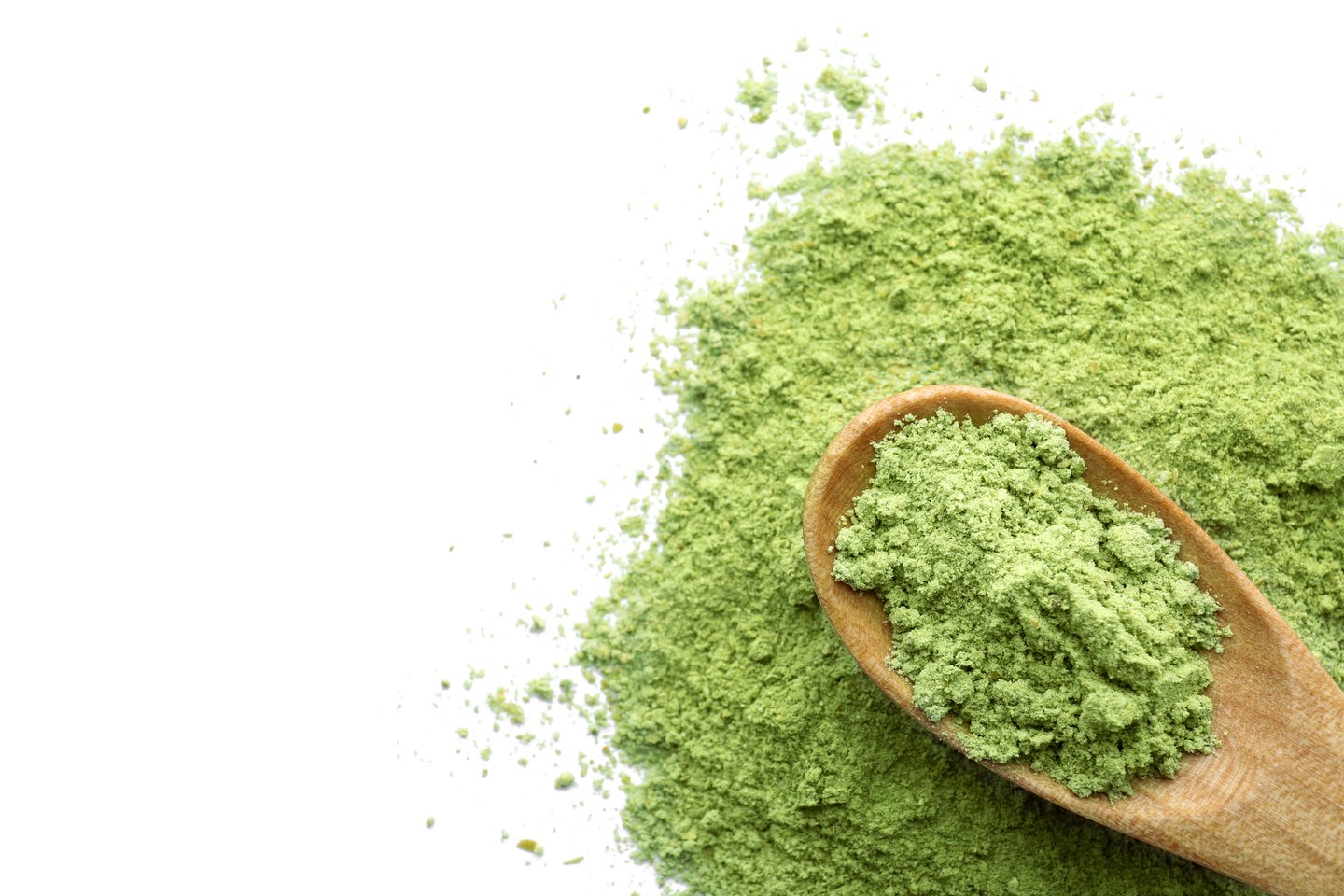 Wooden spoon with matcha powder on white background, top view