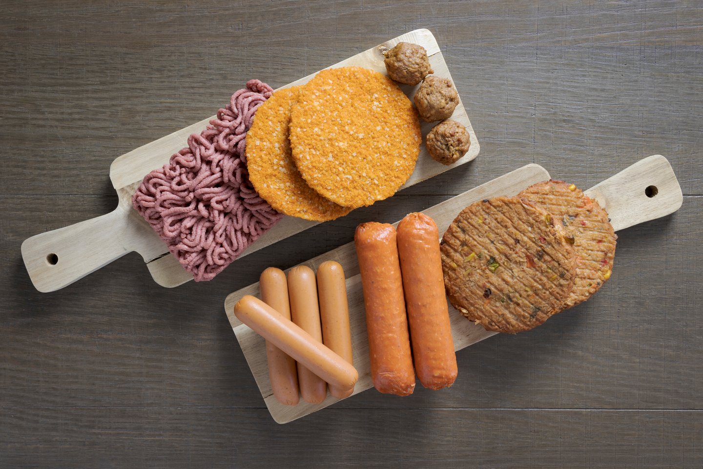 Flat lay of plant based vegetarian meat products for a plant based diet on a wooden table