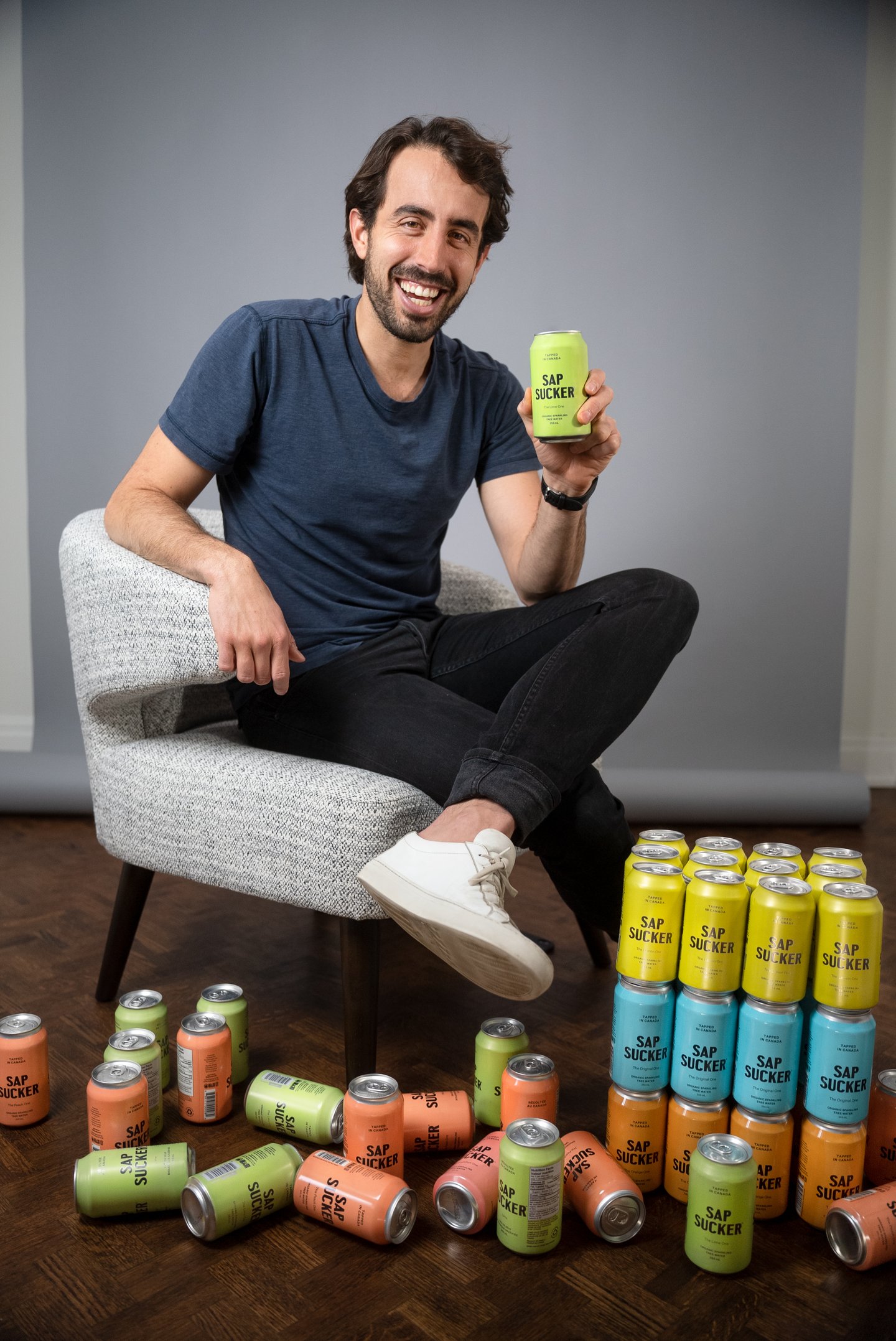 Ryan Klein surrounded by cans of Sapsucker