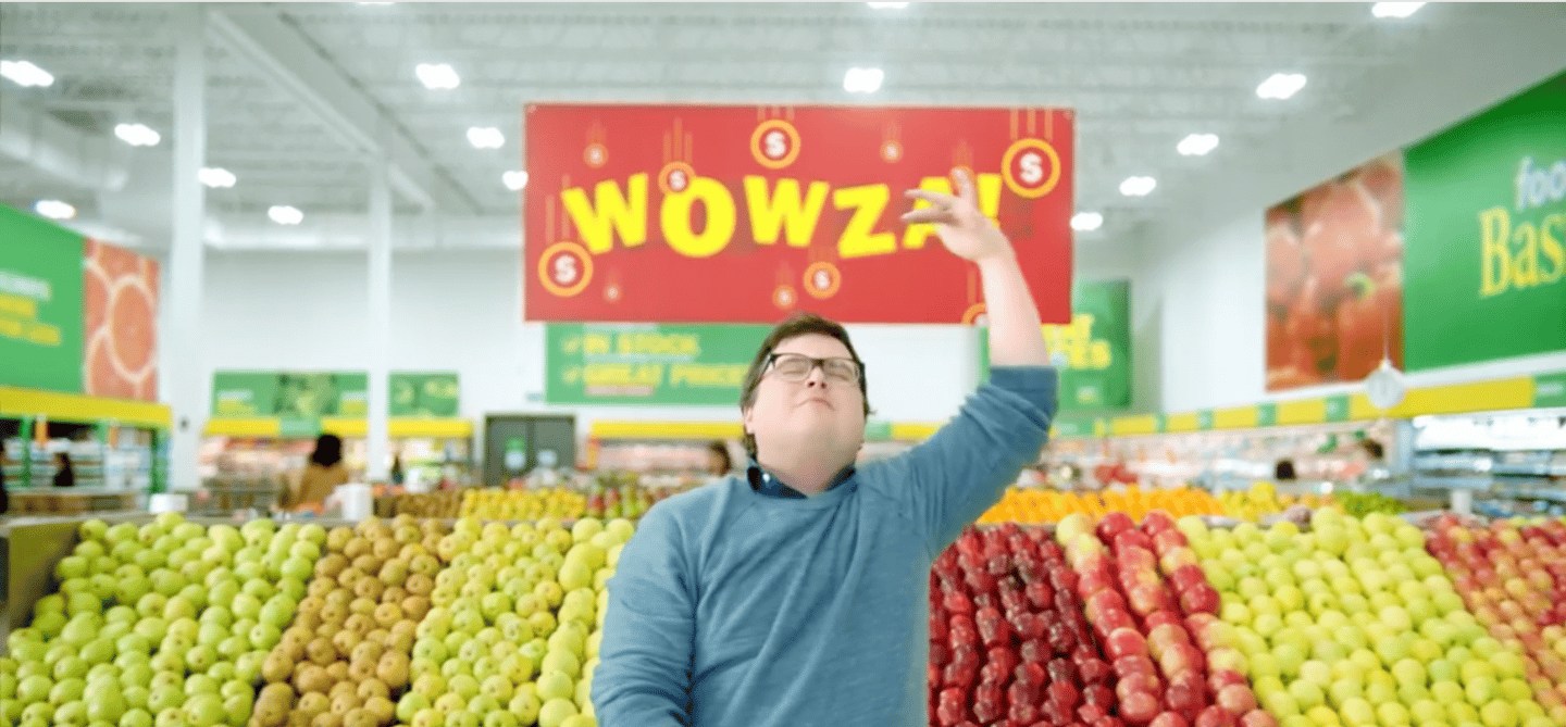 A man standing in the produce section of a Food Basics store shopping the Wowza sale