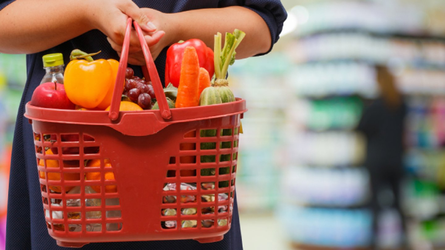 woman holding grocery basket