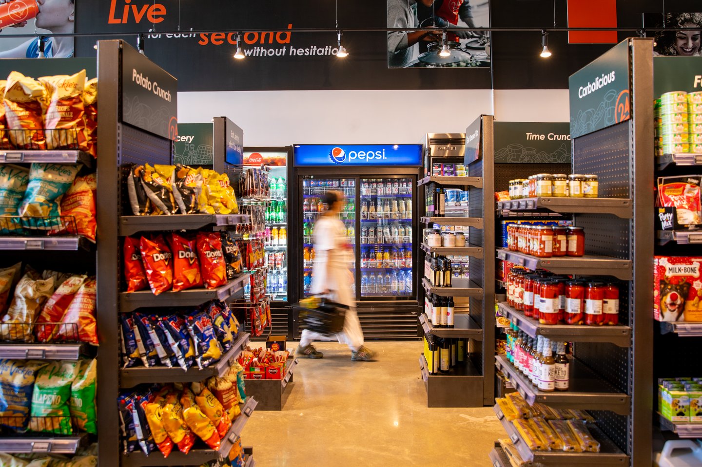 A woman shopping in Aisle24 convenience store