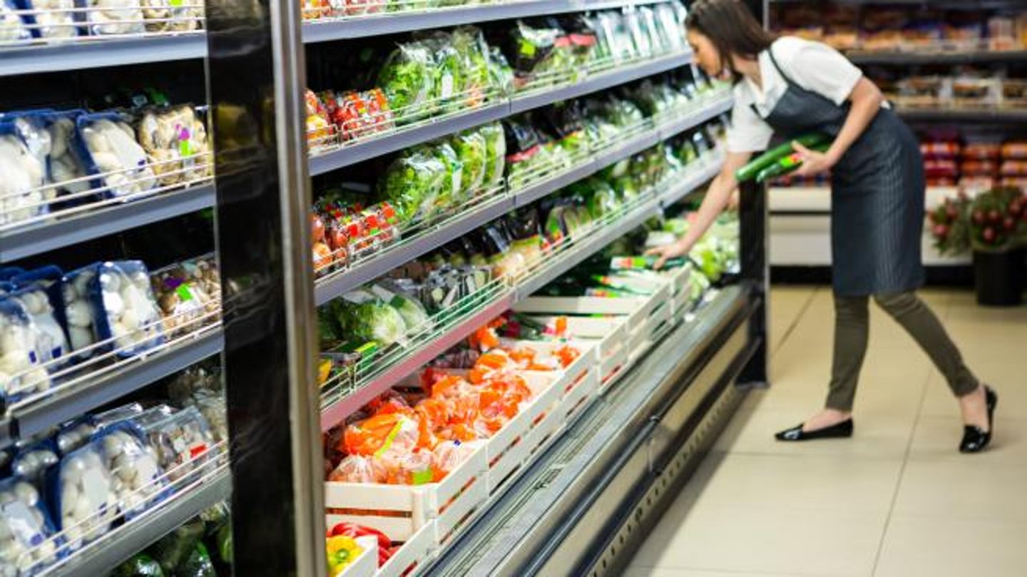 grocery worker stocking shelves