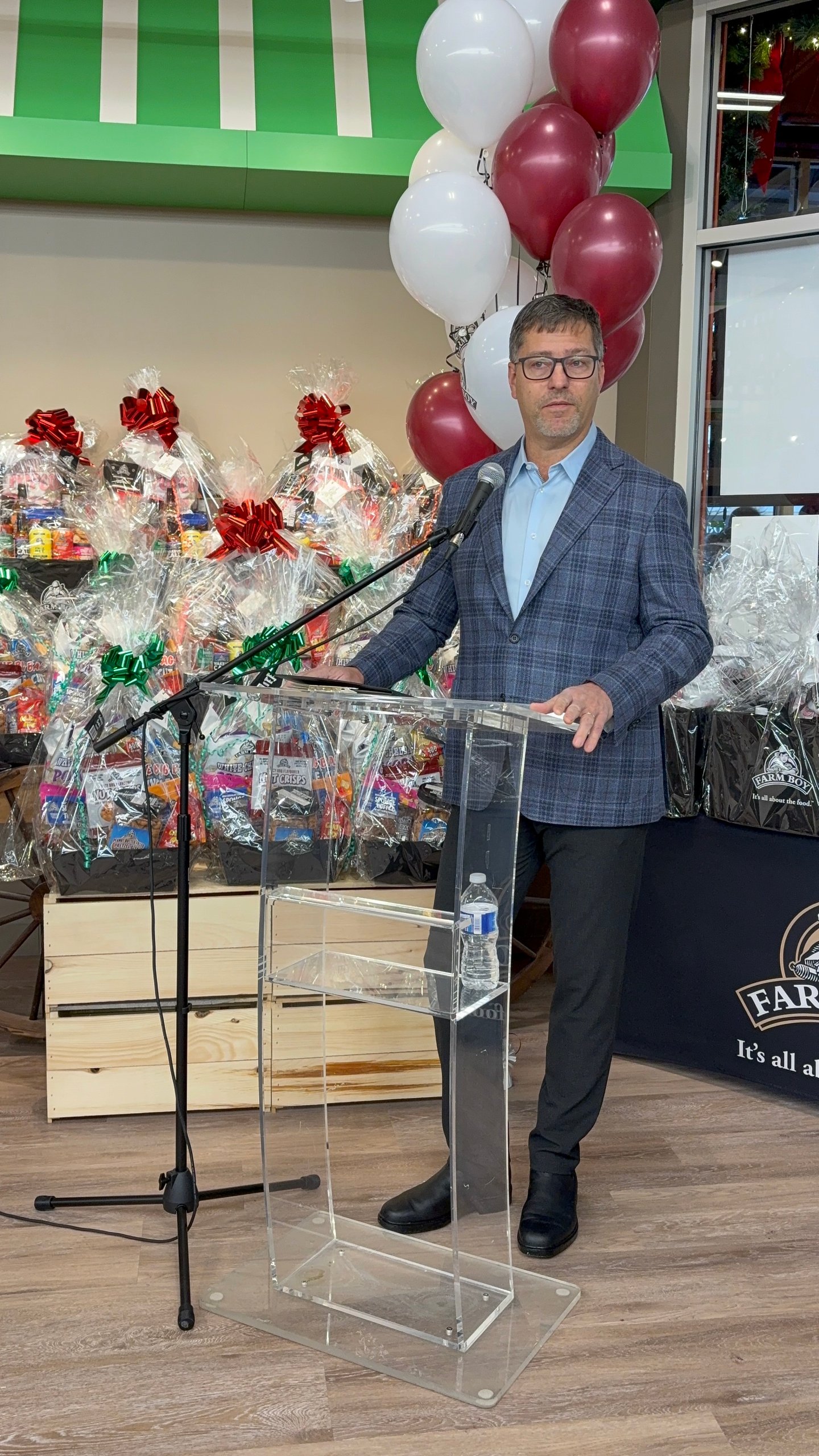 Farm Boy president Shawn Linton standing behind a podium giving a speech