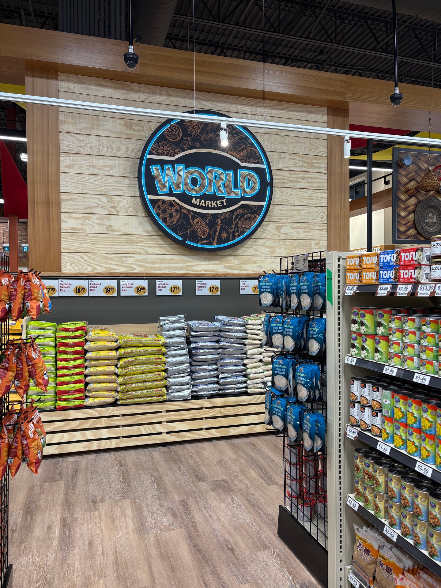 "World Market" sign on a grocery store wall at the end of food aisles