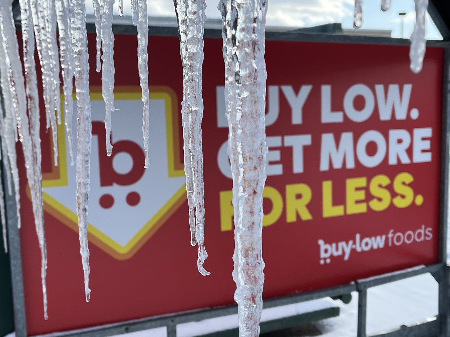 Icicles hanging off a Buy Low sign