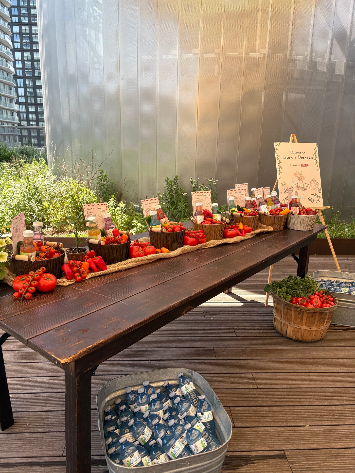 a table filled with little metal buckets of tomatoes