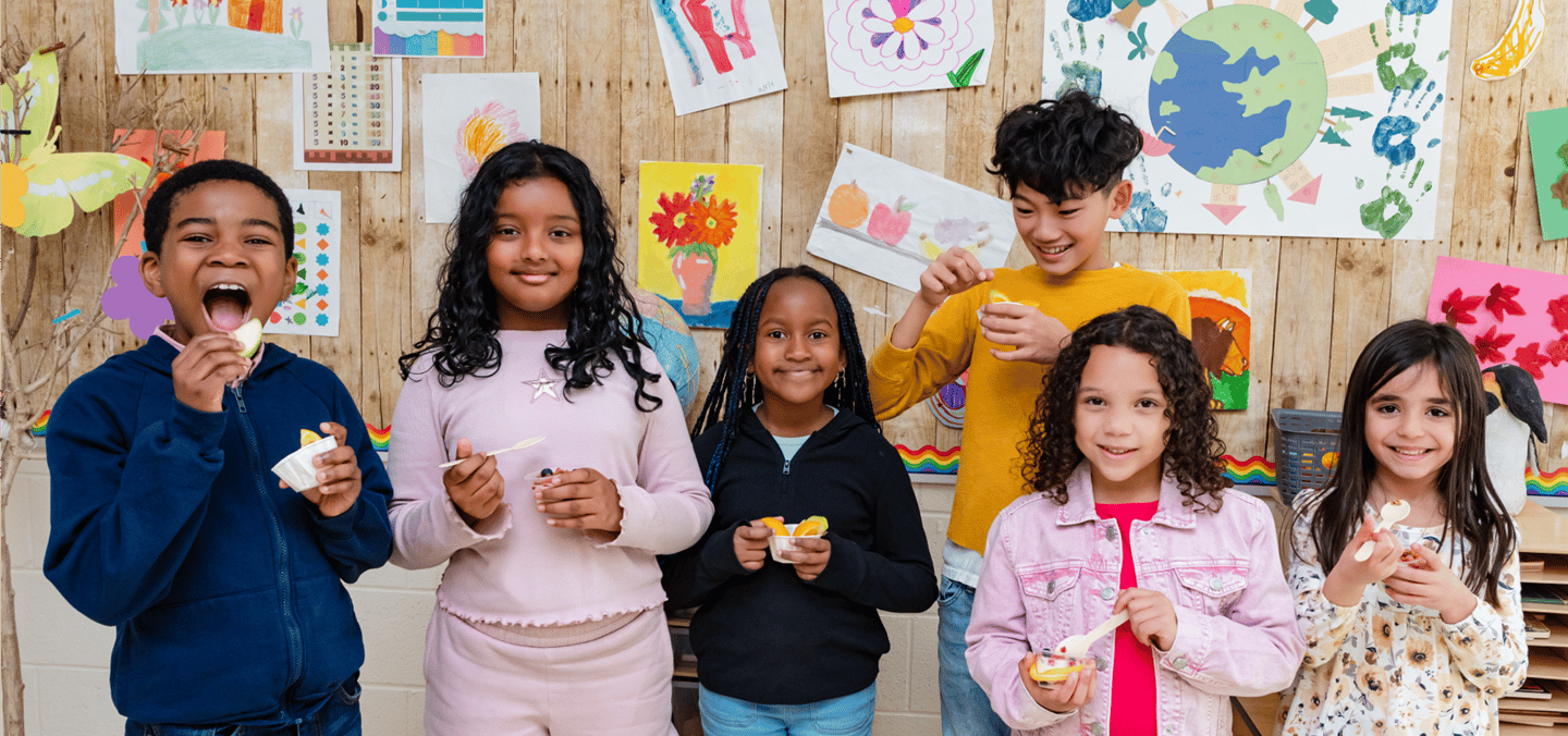 A group of school-aged children holding snacks