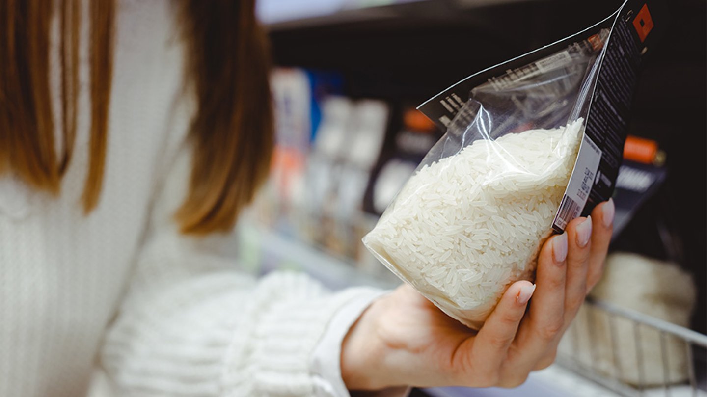 A femal holding a bag of rice