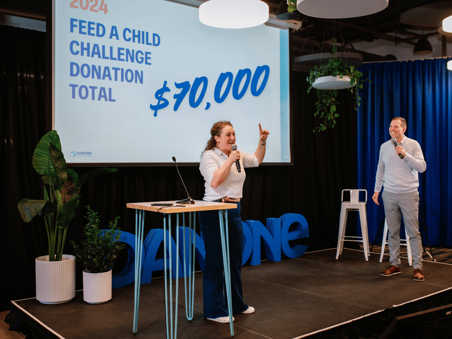 a woman standing on a stage with a microphone