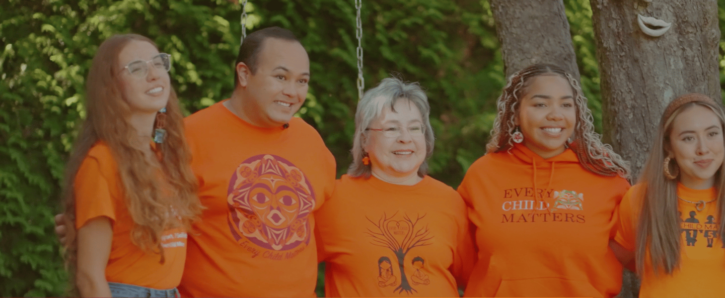 Group of men and women wearing orange T-shirts