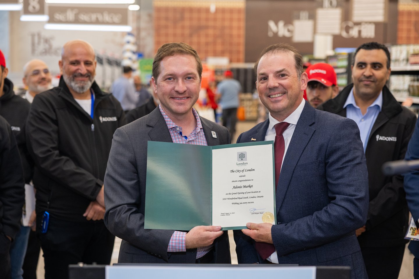 Mayor of London Josh Morgan (left) giving Eric Provost a congratulatory letter for the opening of the banner’s first location in the city 