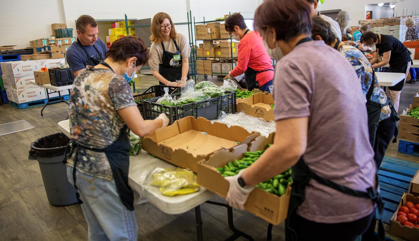 Volunteers packing boxes with food
