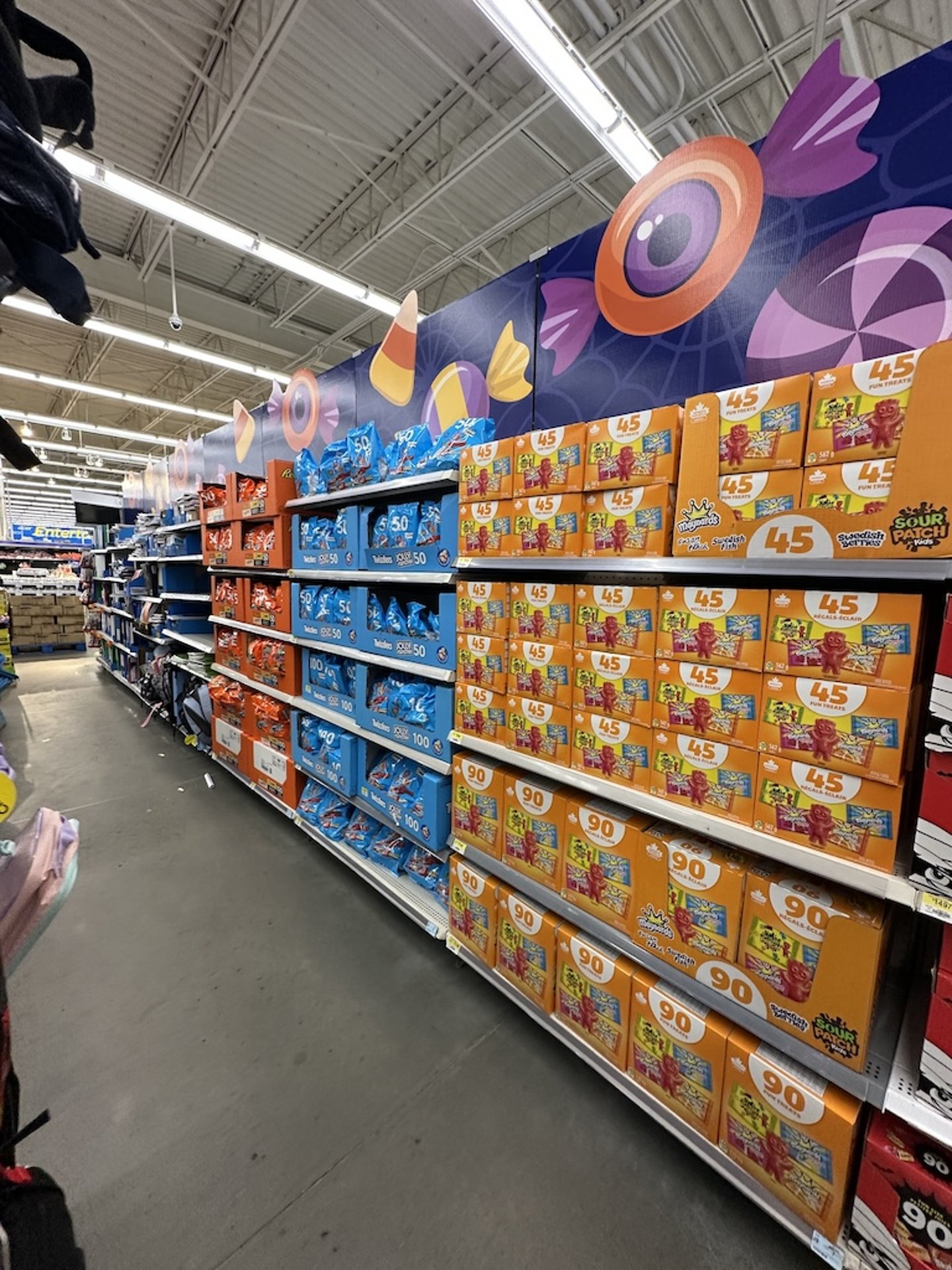 Halloween candy displays in a grocery store aisle 