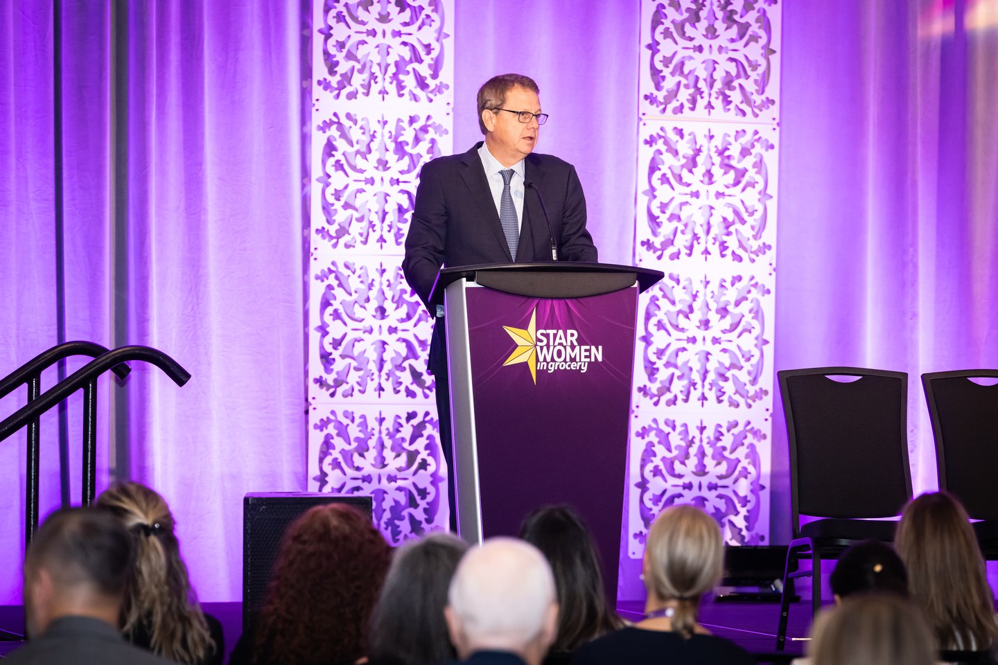 Michael Medline standing at a podium