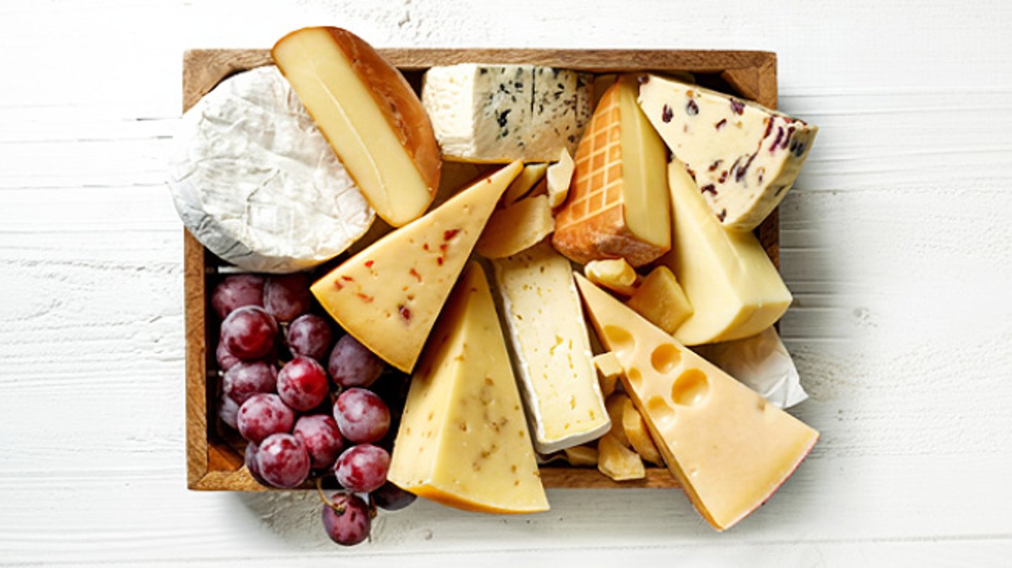 A collection of cheese displayed on a board