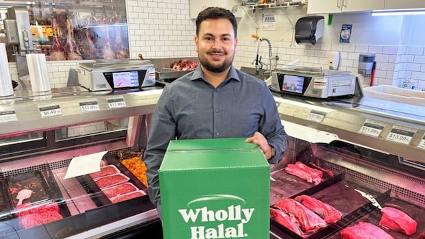 Faaez Al-hendi, founder of Wholly Halal poses with a box. 