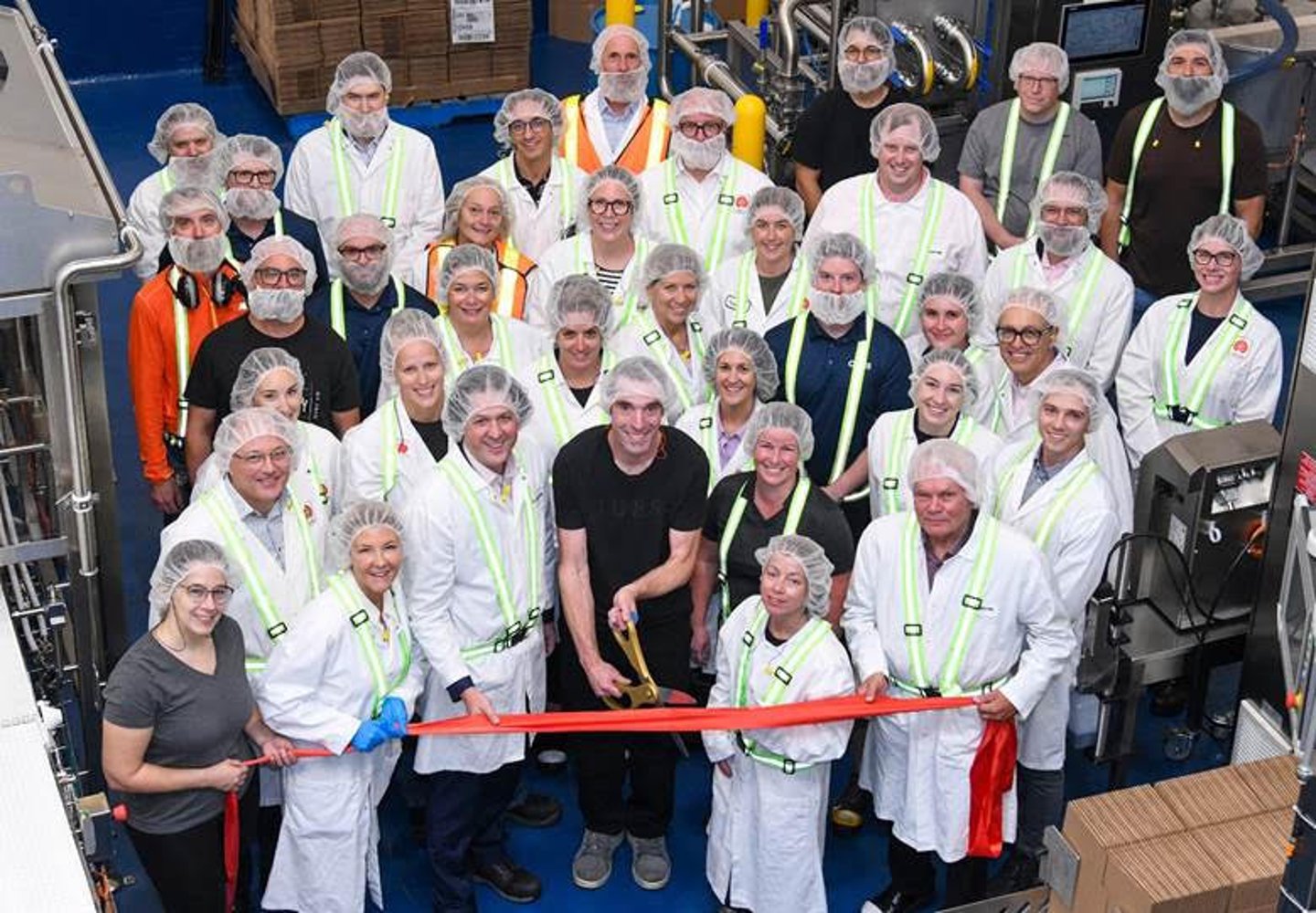 Lassonde team at a ribbon cutting for its new production line
