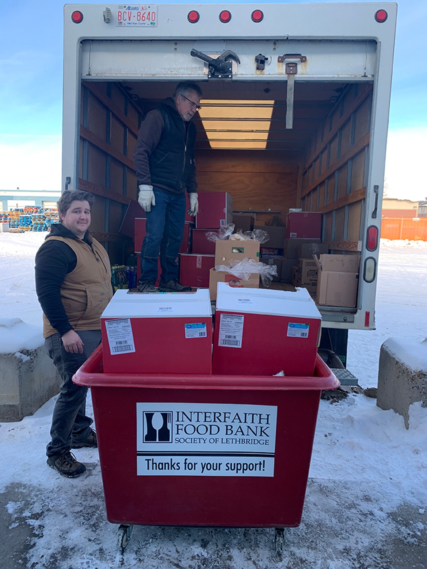Food bankers loading the back of a truck