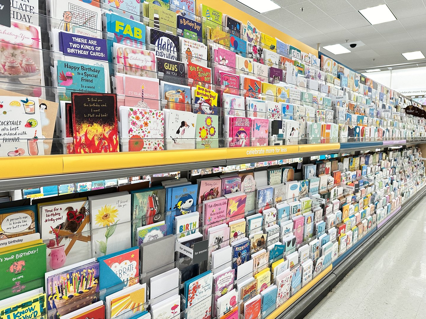 The shelves are filled with a wide variety of cards featuring colorful designs and messages for all ages and occasions at Target retail store.