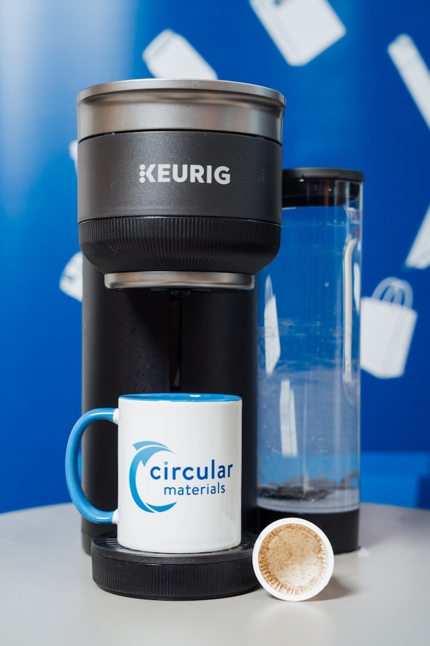 Keurig Dr Pepper K-Cups in the machine with a mug with the Circular Material logo