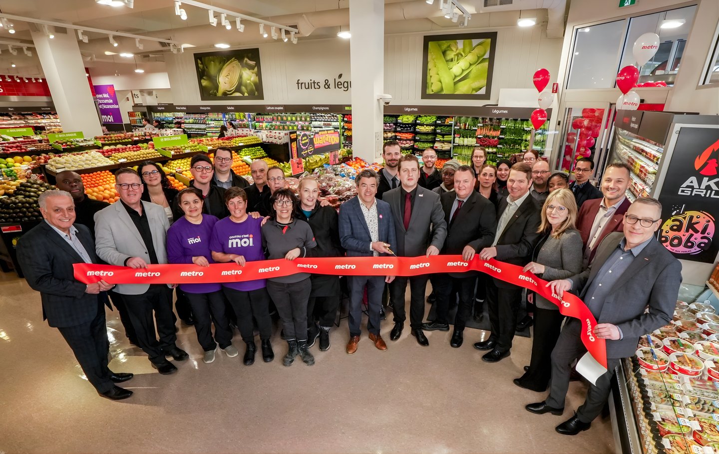 Metro Plus employees cutting a ribbon at the store opening in Montreal