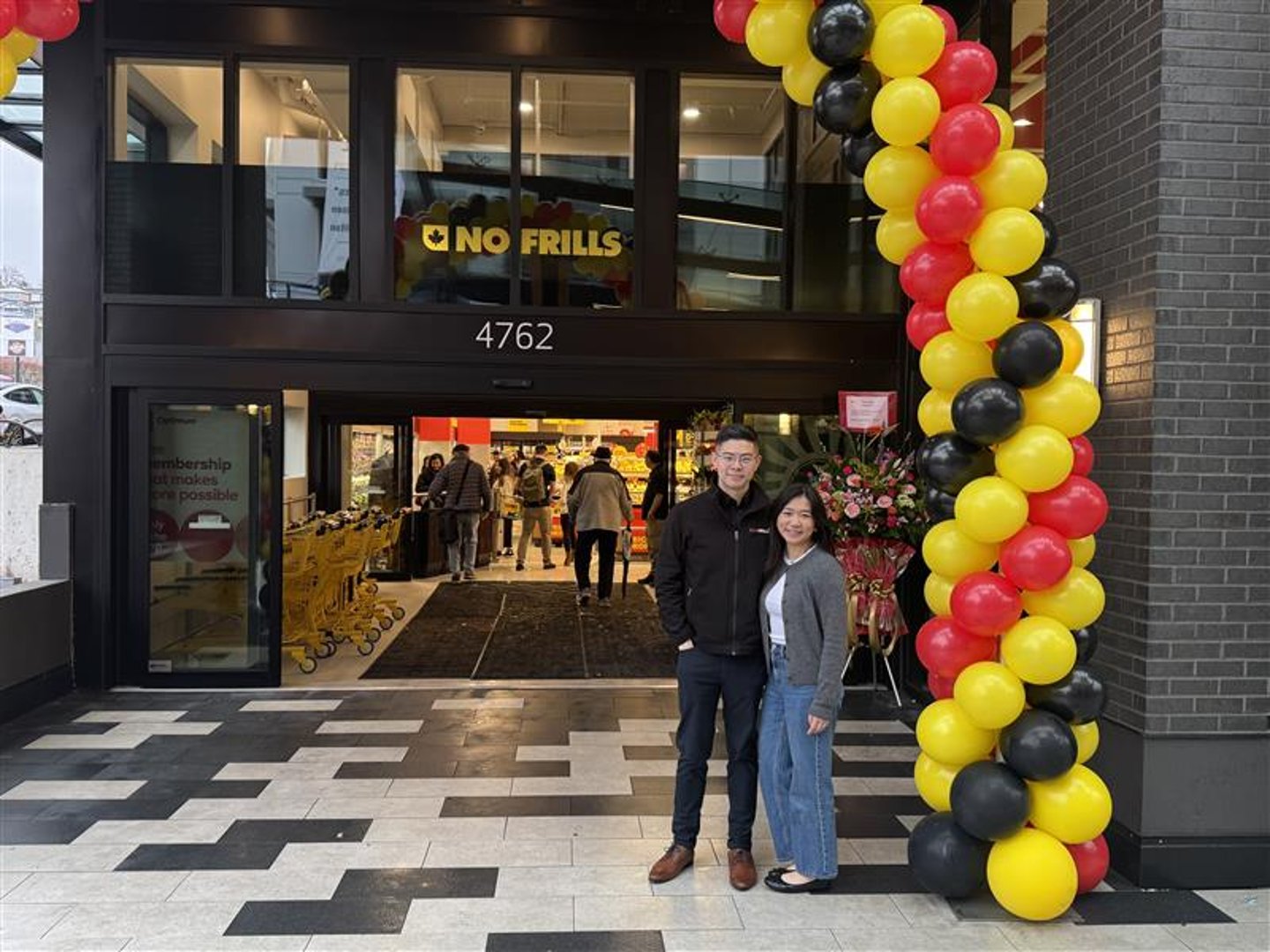 Justin Ng and partner stand outside of the Burnaby, B.C. No Frills location