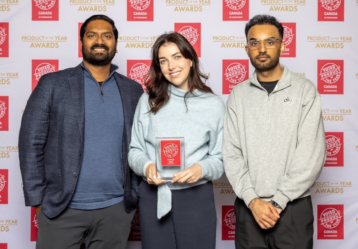 Attendees pose with an award