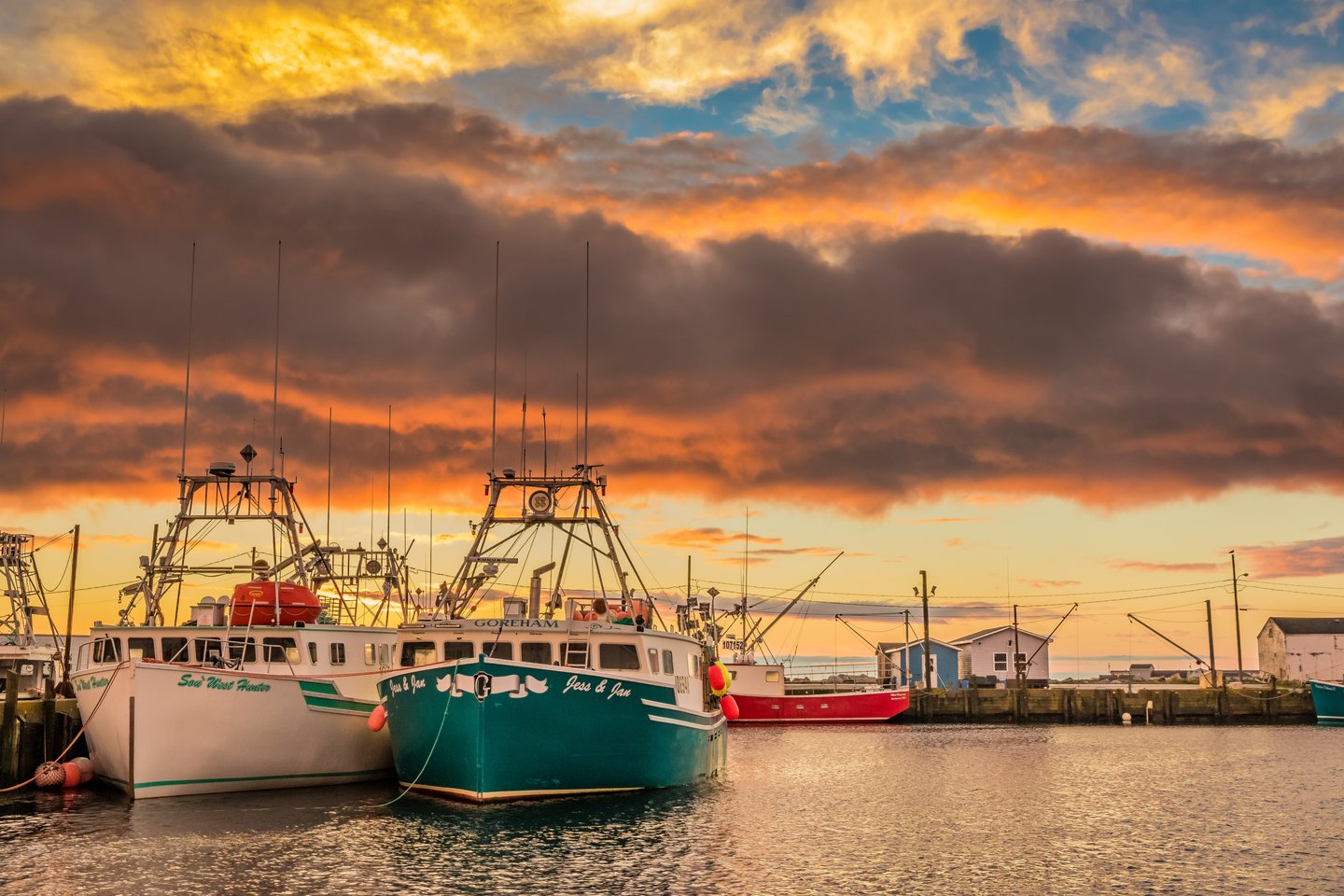 Lobster fishing boats arrive to home port wharf after a long day of pulling traps and gear.