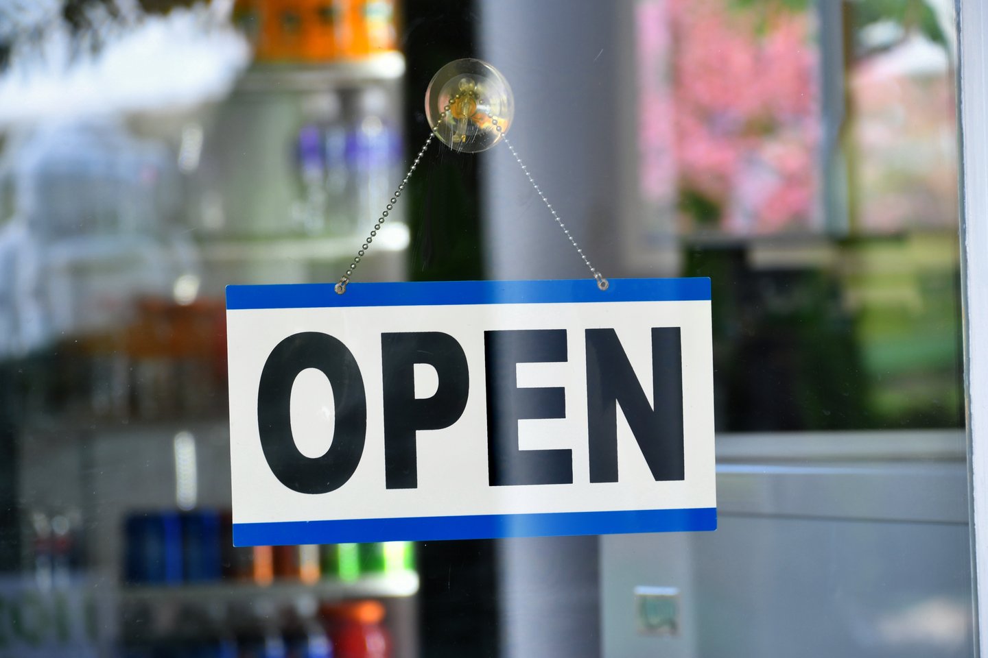 Open sign hanging in the window of a store