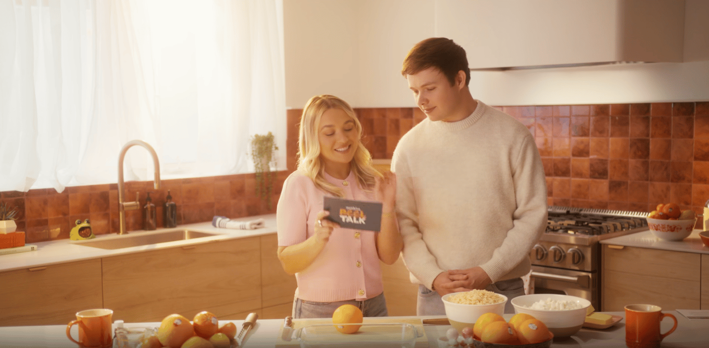 A boy and girl standing behind a kitchen counter