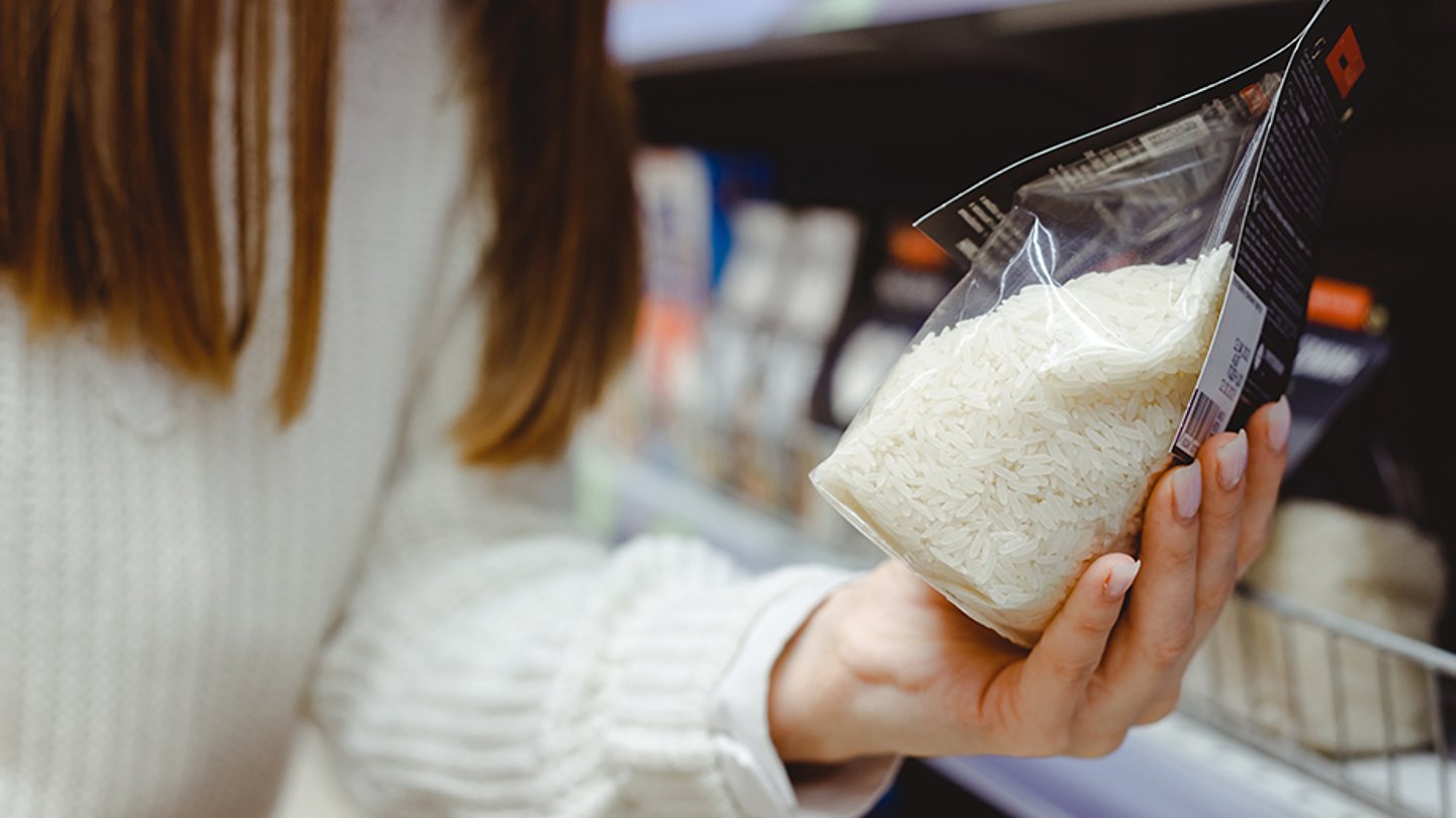 Shopper with a pack of rice in hand