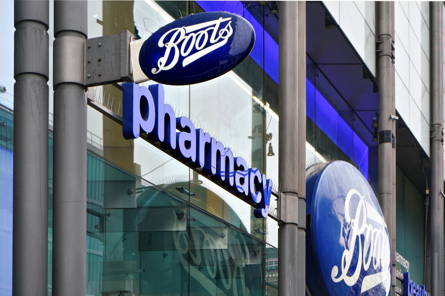 Typical blue oval sign at one of many Boots branches in London. Boots is a health and beauty pharmacy chain in UK and few other countries