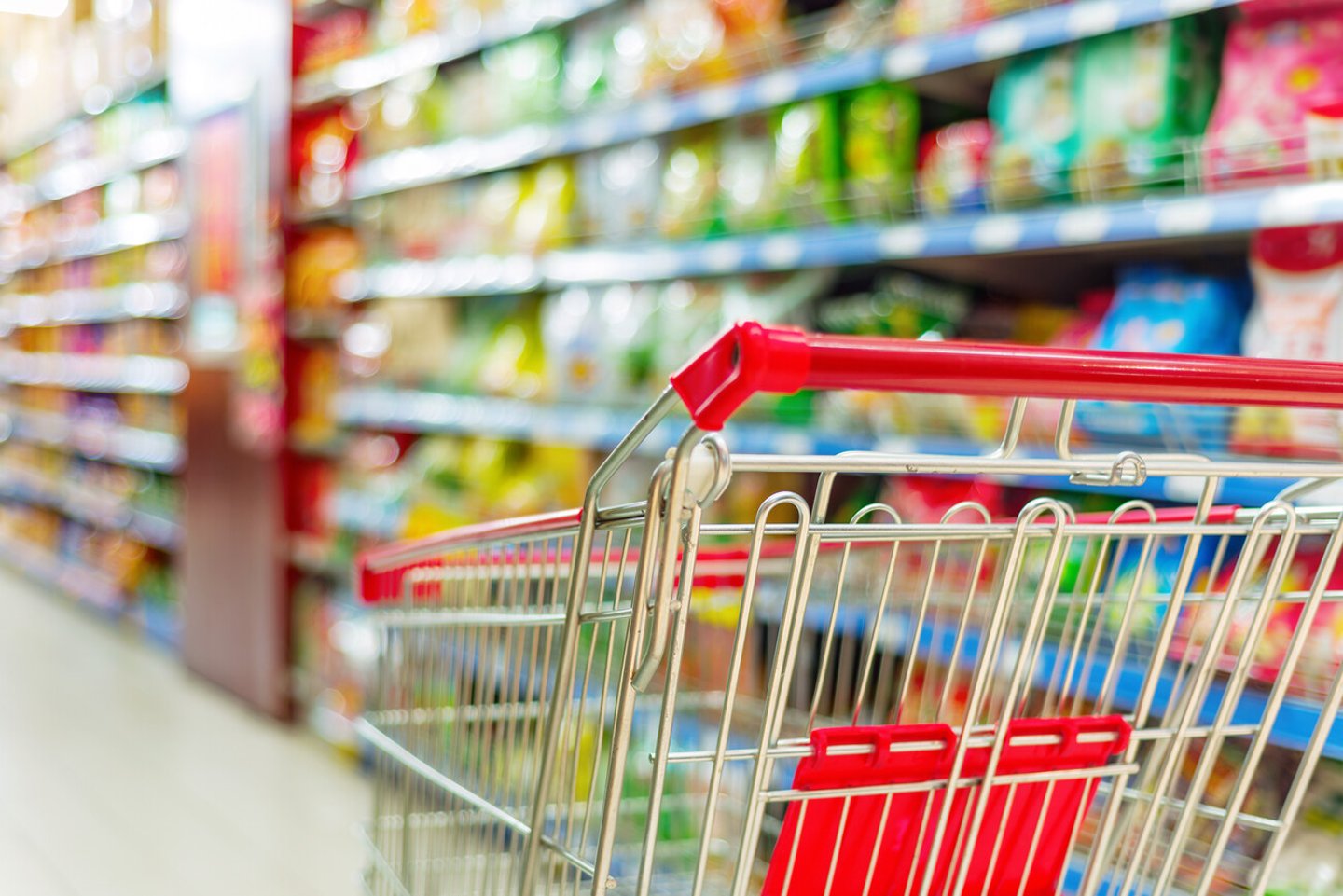 Supermarket interior, empty red shopping cart.; Shutterstock ID 182694926