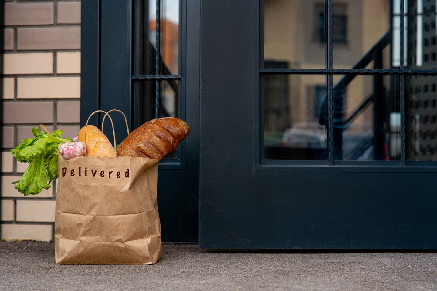 Contactless delivery left at the door during the quarantine. House entrance with delivered bag. Control Epidemic Prevention measures of coronavirus; Shutterstock ID 1698150850