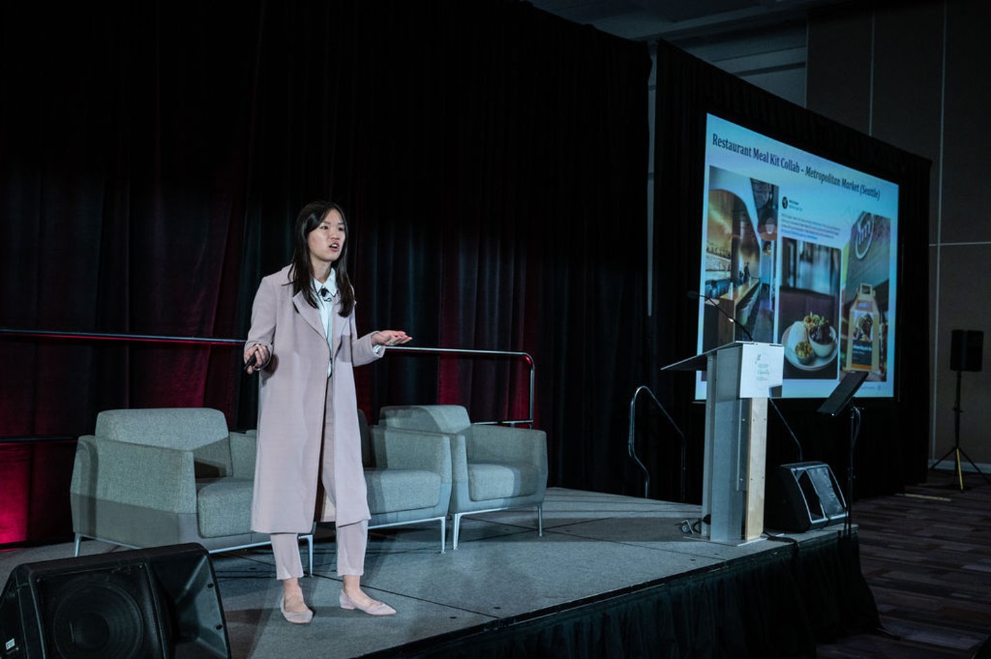 A woman presenting on stage