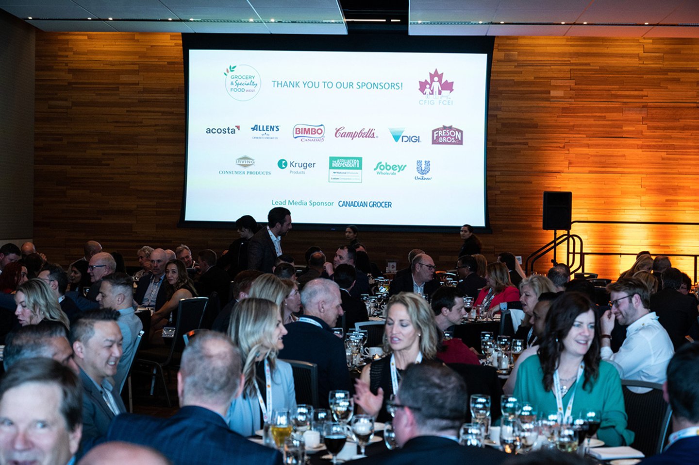 People seated at large tables for dinner