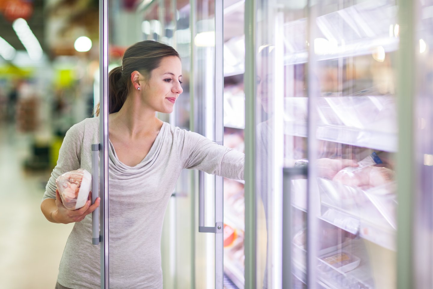 woman shopping for frozen meat