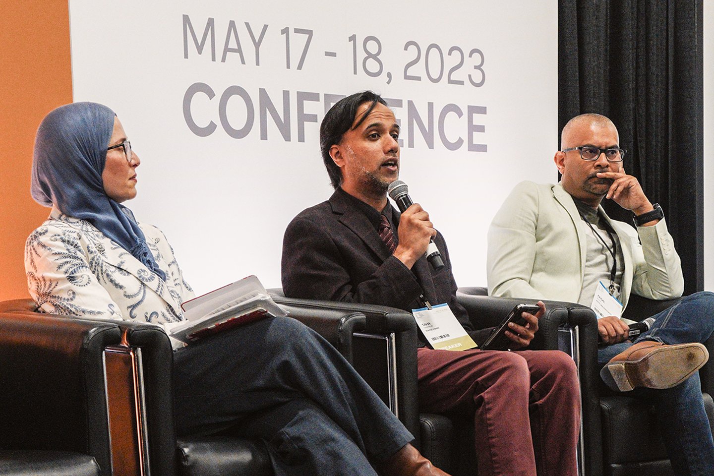 Panelists sitting on a stage