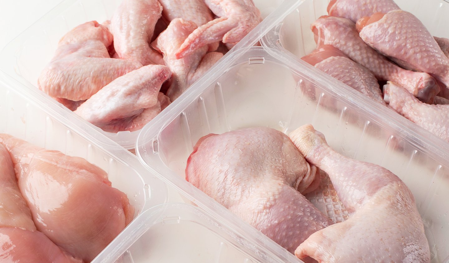 assorted types of raw chicken in packages