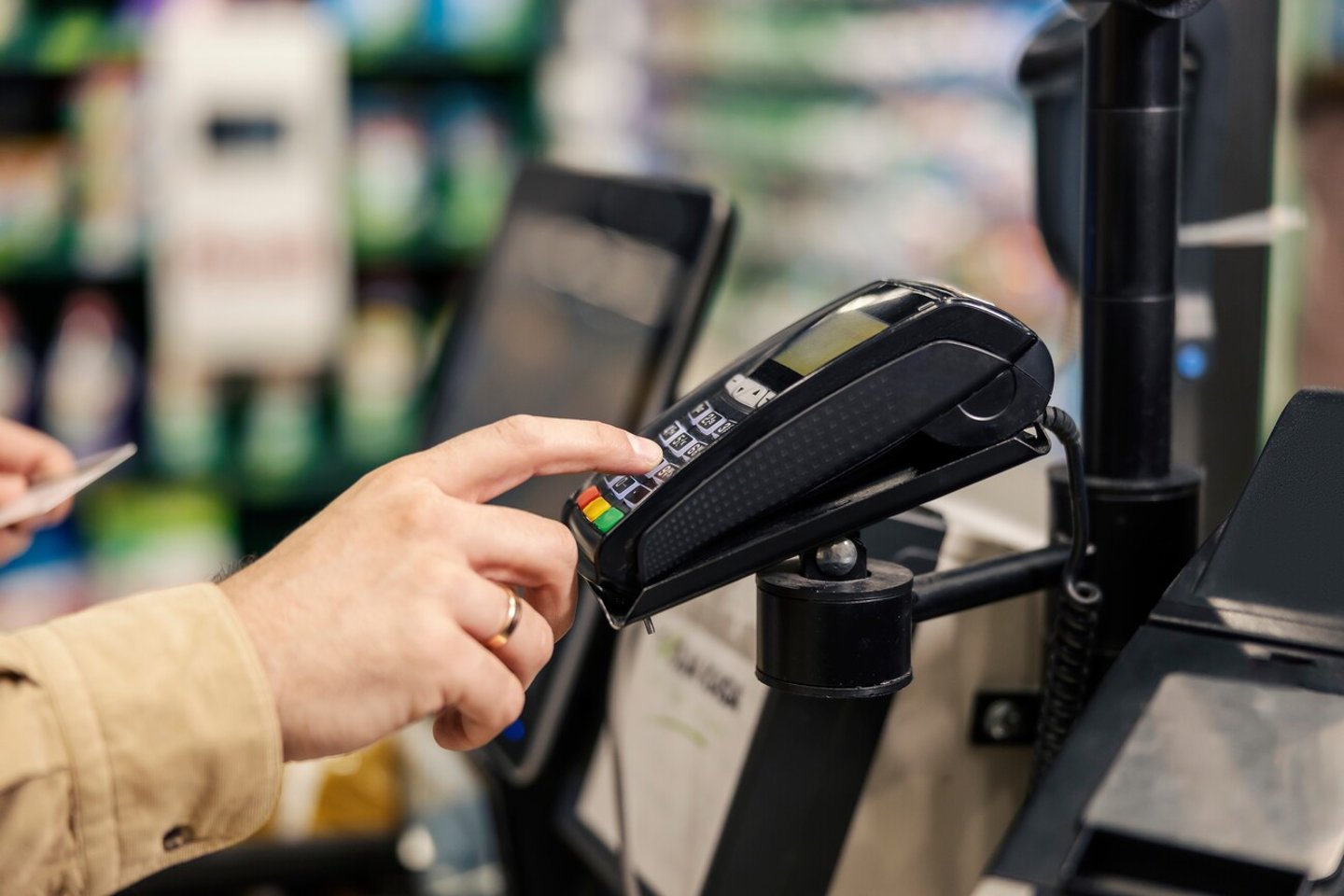 Male's hand entering credit card code at supermarket on pos terminal at self-service checkout.; Shutterstock ID 2227683941