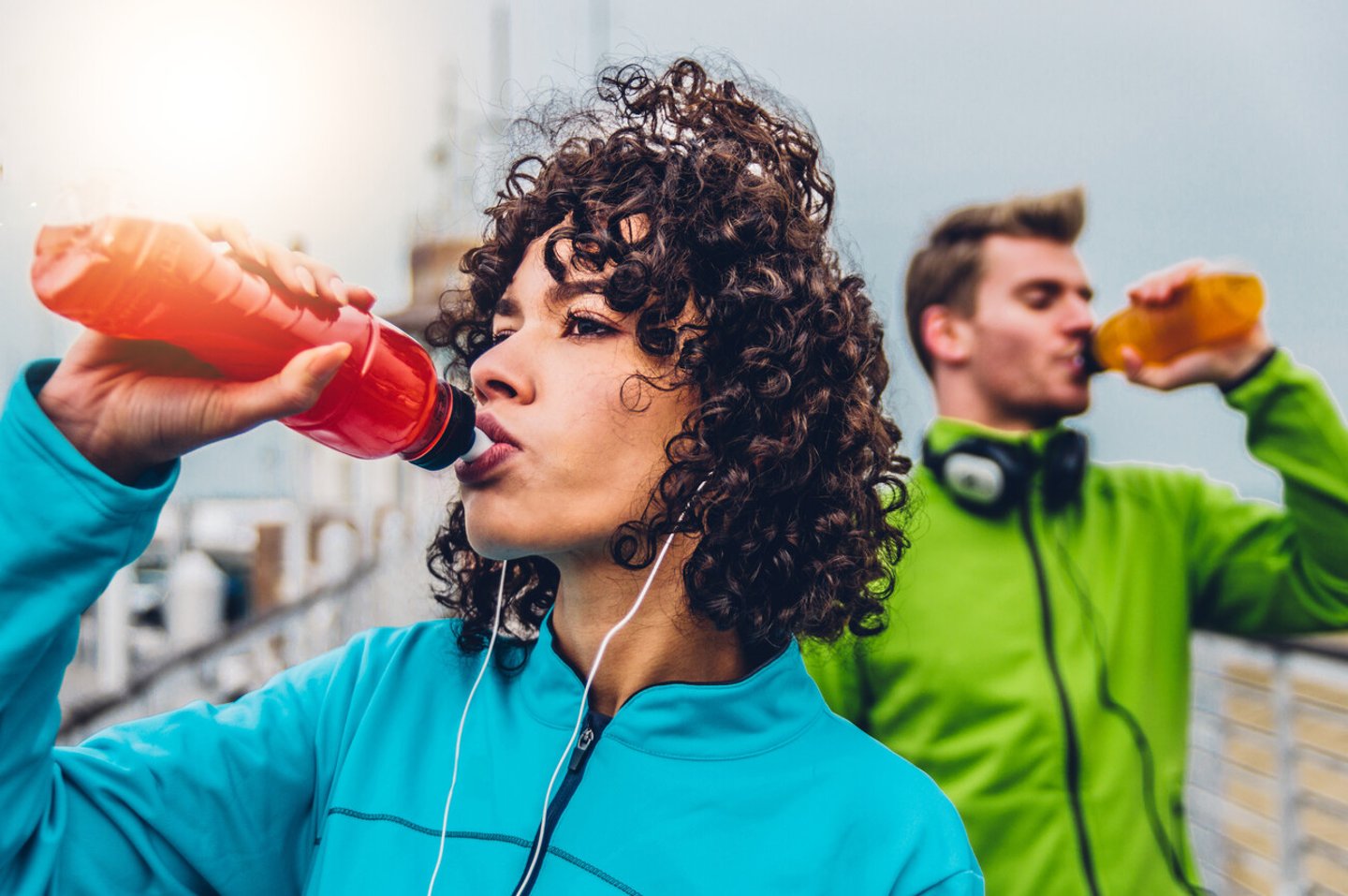 Hispanic runner woman drinking energy drink outdoor ; Shutterstock ID 1838500882