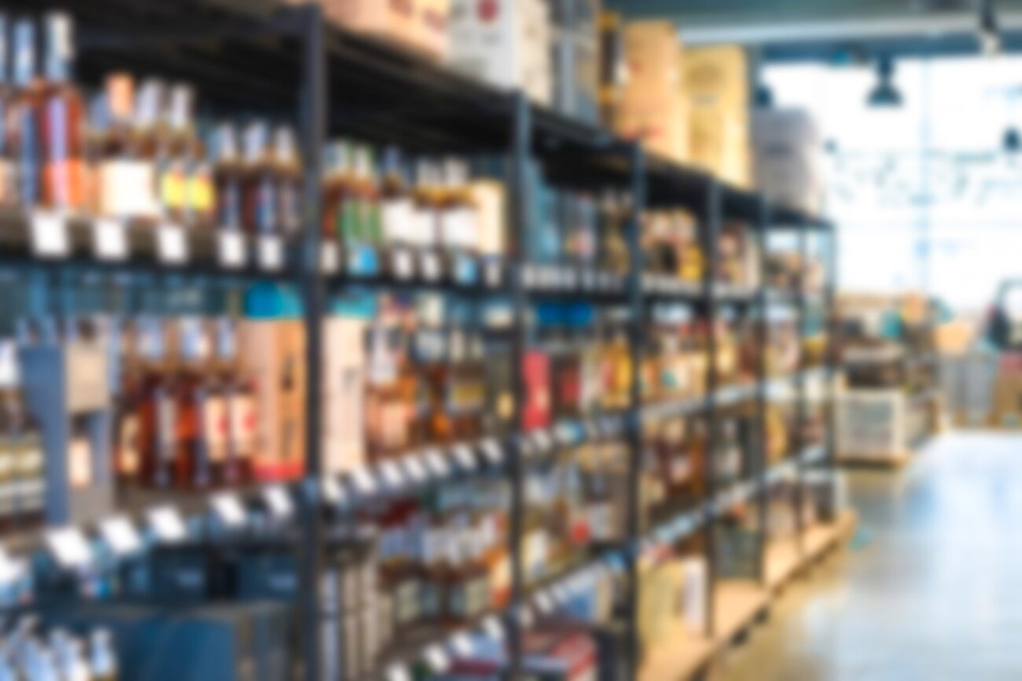 Blur shelves with wine bottles at liquor store as background with copy space. Many blurred bottles with alcohol; Shutterstock ID 2221122677