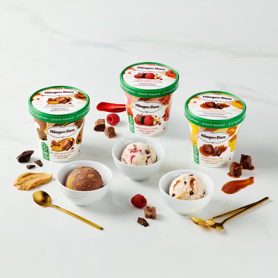 Tubs of Häagen-Dazs Plant-Based Collection sitting on a table with bowls filled with the frozen dessert
